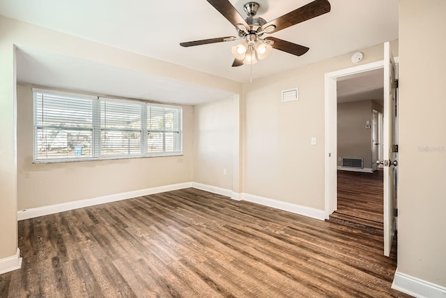 unfurnished room with ceiling fan and dark wood-type flooring