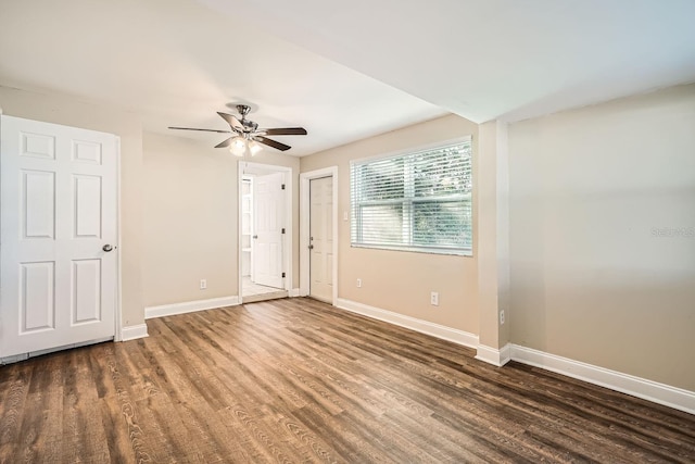 empty room featuring ceiling fan and dark hardwood / wood-style floors