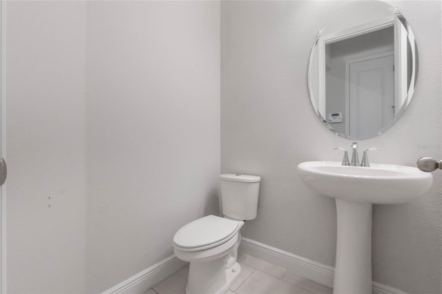 bathroom with tile patterned floors and toilet