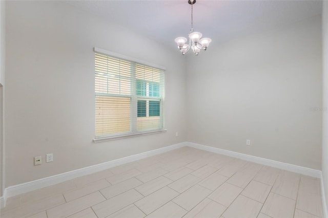 unfurnished room with light tile patterned floors and an inviting chandelier