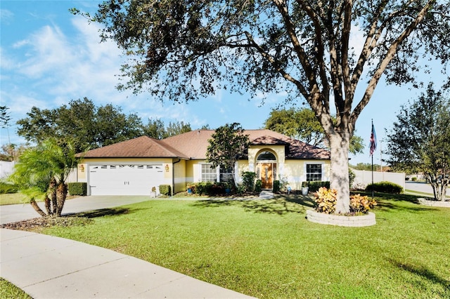 view of front facade with a garage and a front lawn