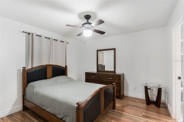 bedroom featuring hardwood / wood-style flooring and ceiling fan