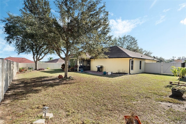 back of house with a lawn