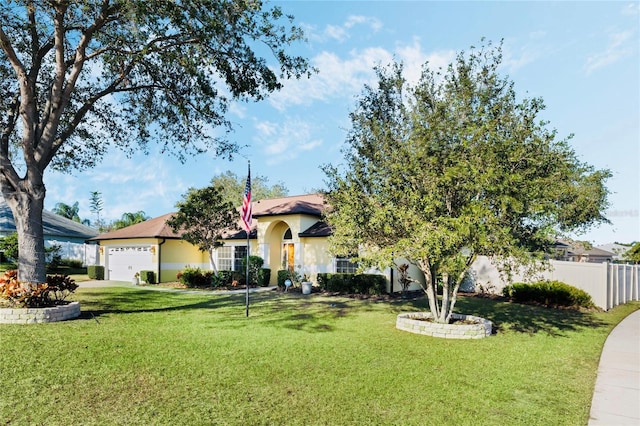 view of front of property with a garage and a front lawn