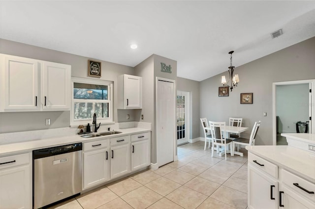 kitchen featuring dishwasher, white cabinets, sink, light tile patterned flooring, and a chandelier