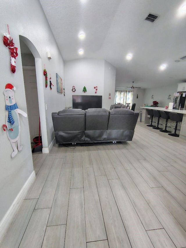 living room with ceiling fan and a textured ceiling