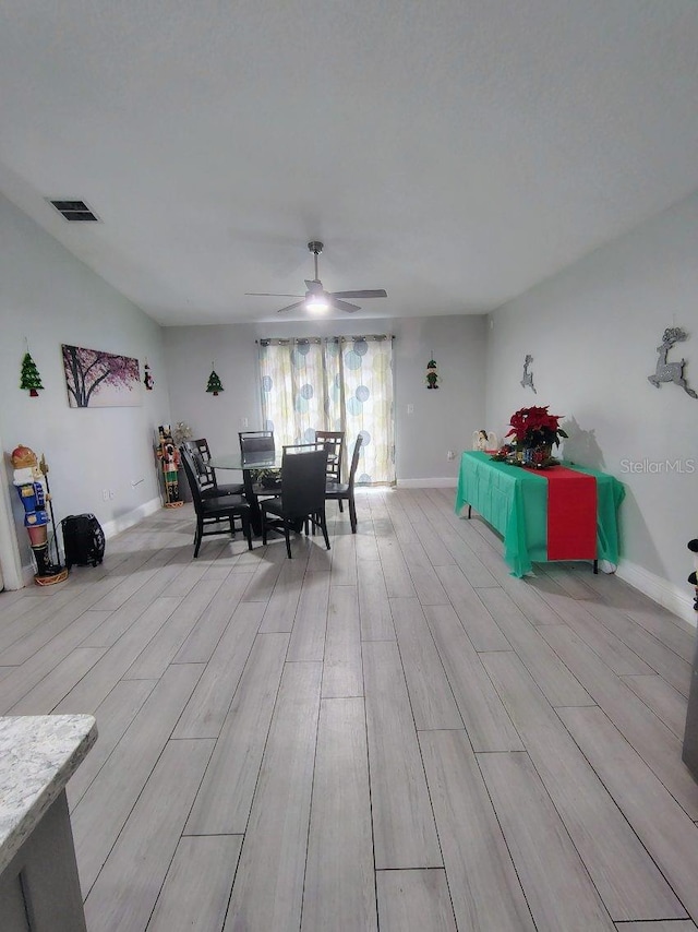 dining area with ceiling fan and light hardwood / wood-style floors