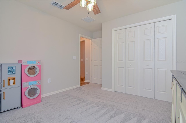 game room with ceiling fan and light colored carpet