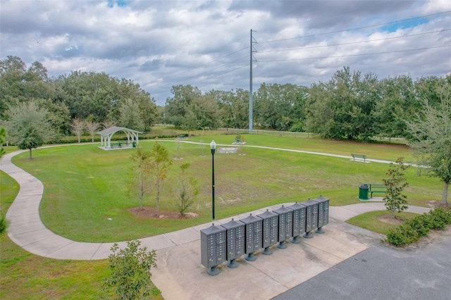 view of community with a gazebo, mail boxes, and a yard