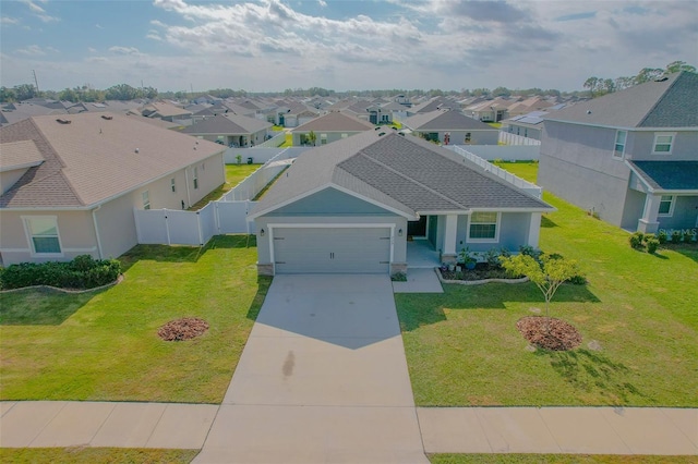 view of front of home featuring a garage and a front yard