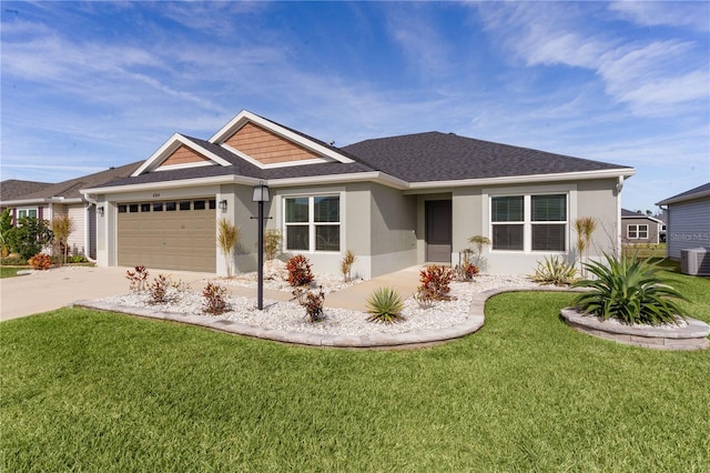 view of front of home with a garage, a front yard, and central AC