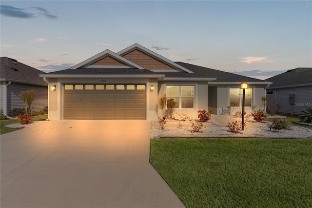 view of front of home featuring a lawn and a garage