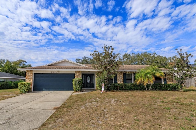 single story home featuring a garage and a front lawn