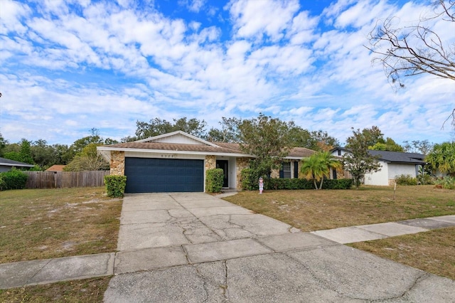 ranch-style house with a garage and a front lawn