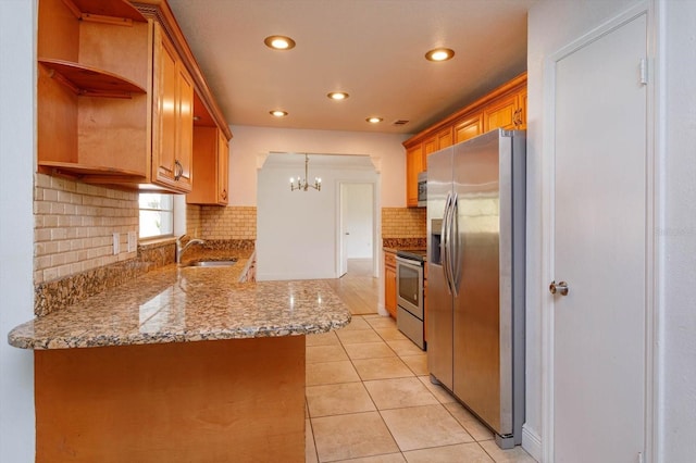 kitchen featuring sink, stainless steel appliances, tasteful backsplash, kitchen peninsula, and light tile patterned flooring