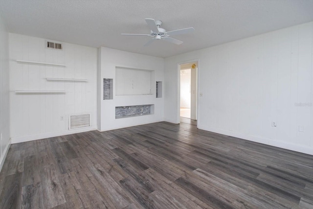 unfurnished living room with a textured ceiling, dark hardwood / wood-style floors, and ceiling fan