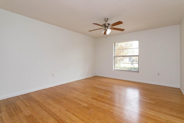 spare room featuring ceiling fan, light hardwood / wood-style floors, and a textured ceiling