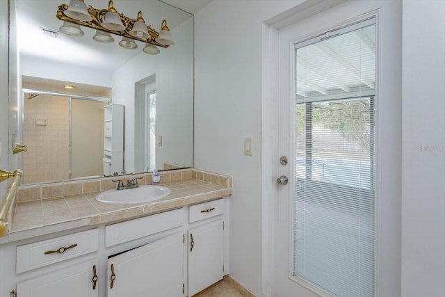 bathroom featuring vanity and an enclosed shower