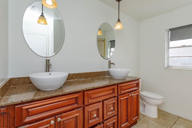 bathroom with tile patterned floors, vanity, and toilet