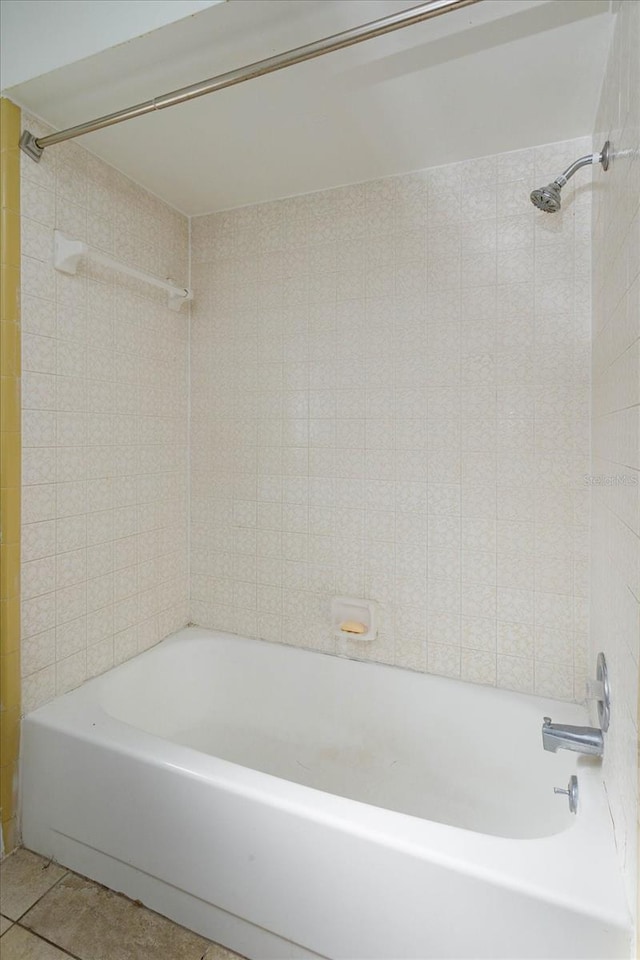 bathroom featuring bathing tub / shower combination and tile patterned flooring