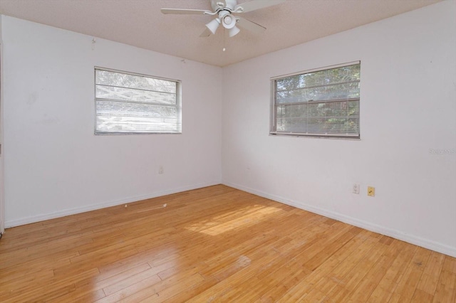 unfurnished room featuring ceiling fan, a textured ceiling, and light wood-type flooring