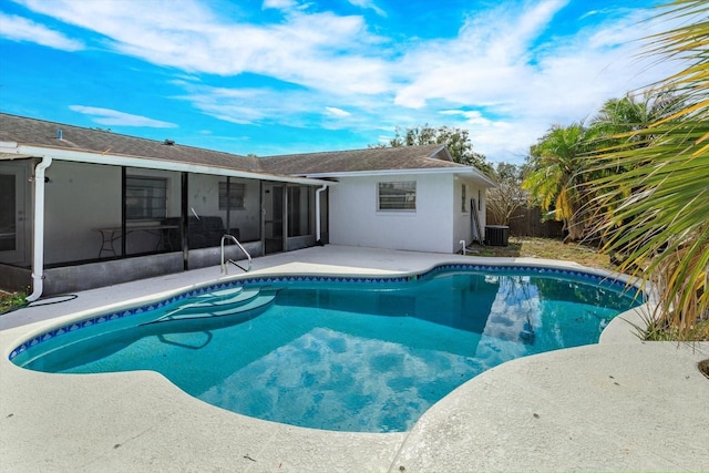 view of swimming pool with a sunroom and cooling unit