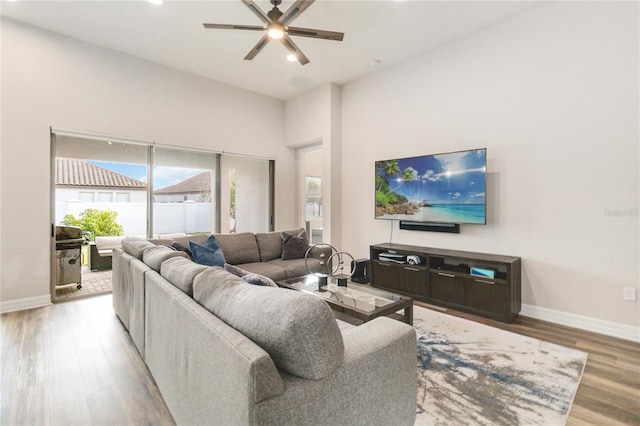 living room featuring ceiling fan and light wood-type flooring