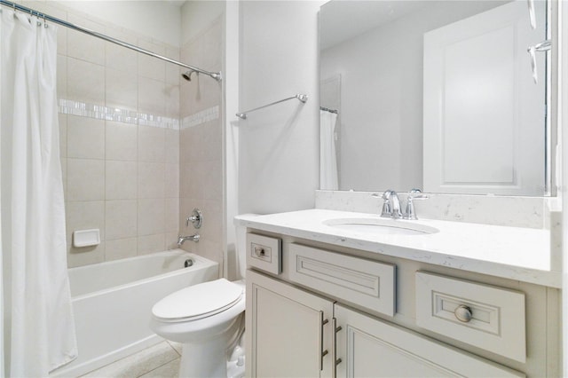 full bathroom featuring tile patterned floors, shower / tub combo with curtain, vanity, and toilet