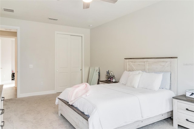 bedroom featuring ceiling fan, a closet, and light carpet