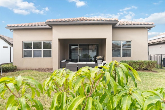 rear view of property featuring an outdoor living space and a lawn