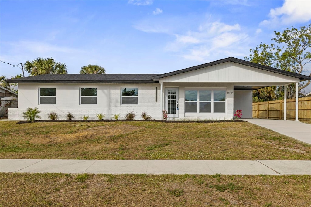 ranch-style house with a carport and a front yard