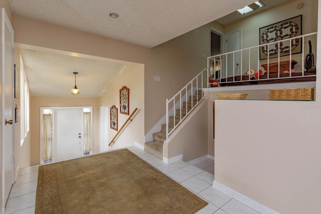 tiled foyer entrance with a textured ceiling