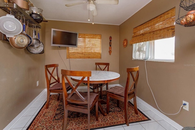 dining space featuring light tile patterned floors and ceiling fan