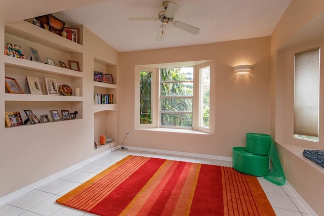 tiled bedroom featuring ceiling fan and a textured ceiling