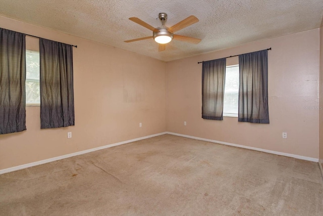 spare room with carpet flooring, ceiling fan, and a textured ceiling