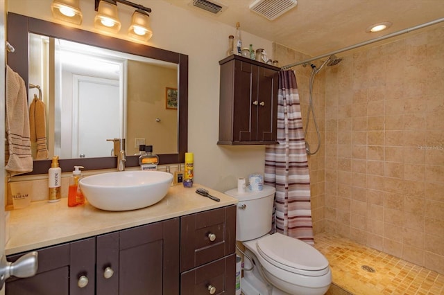 bathroom with vanity, curtained shower, and toilet