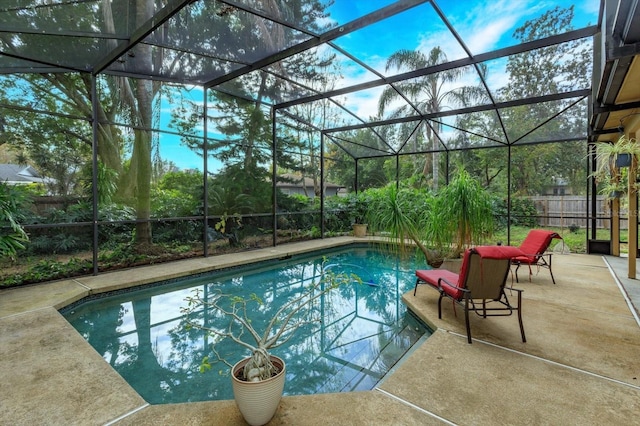 view of swimming pool featuring a patio area and a lanai