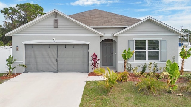 view of front facade featuring a front yard and a garage