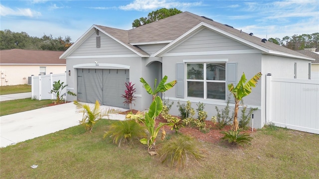 view of front of property featuring a front yard and a garage