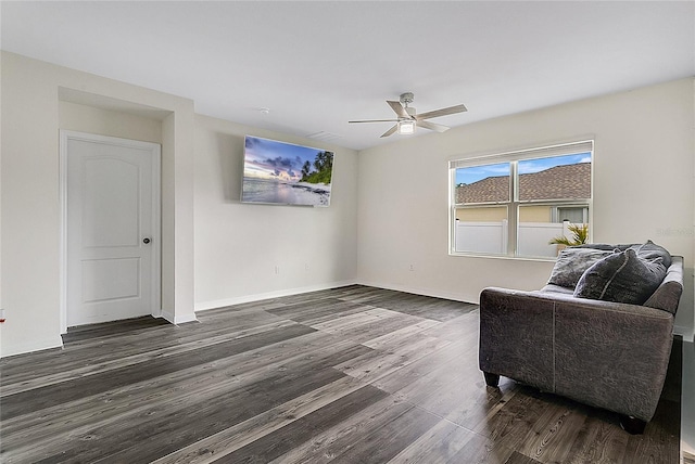 sitting room featuring dark hardwood / wood-style flooring and ceiling fan