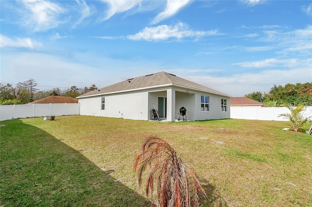 rear view of property with a yard