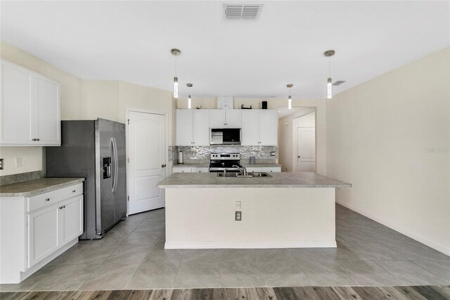 kitchen featuring visible vents, white cabinets, appliances with stainless steel finishes, and a sink