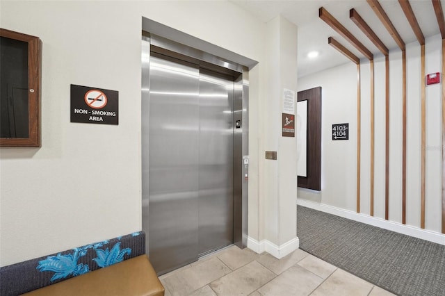 interior space featuring tile patterned flooring and elevator