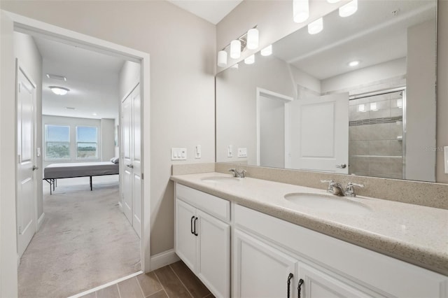 bathroom featuring vanity and an enclosed shower