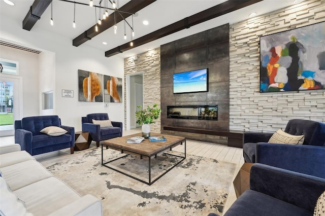 living room with a fireplace and beamed ceiling