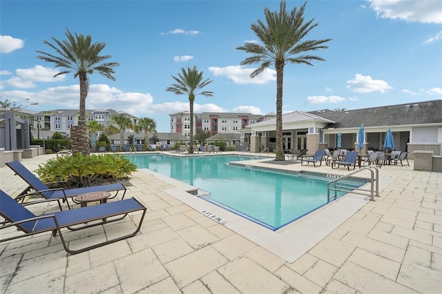 view of swimming pool featuring a patio area