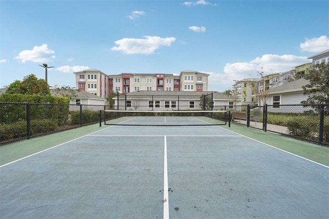 view of tennis court featuring basketball hoop