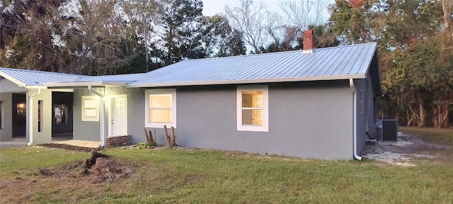 rear view of house with a yard and central air condition unit