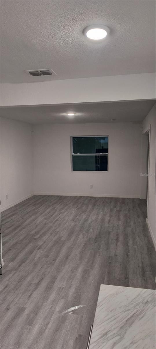 spare room with hardwood / wood-style flooring