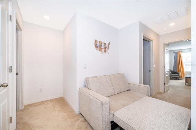 living area with light colored carpet